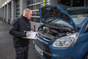 Mechanic inspecting Ford Transit Custom as part of Ford's Transit24 service